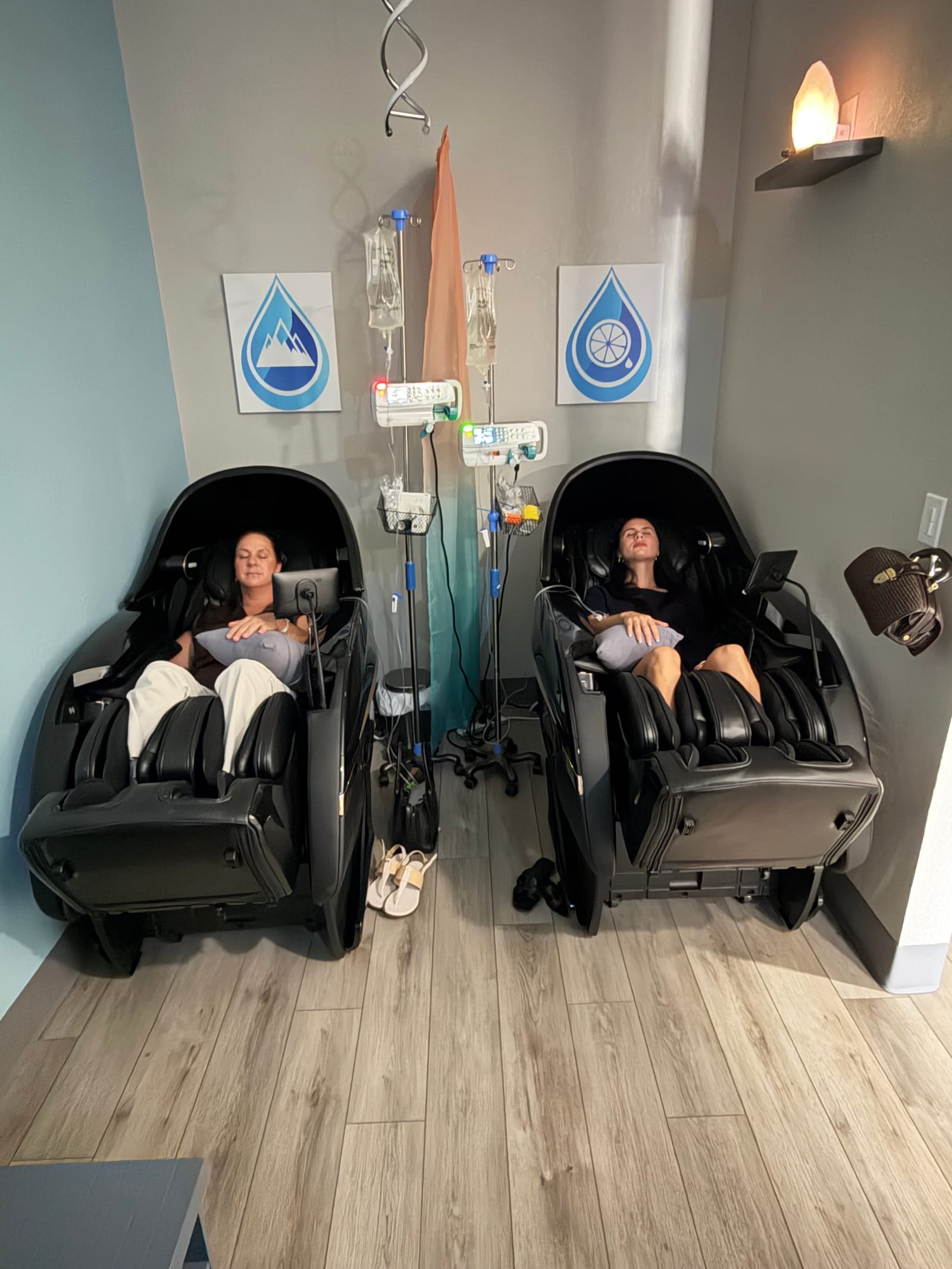 Two clients relaxing in heated massage chairs while receiving IV drips at Prime IV Palm Harbor